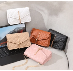 Close-up of quilted chain flap bags with gold tassel detail in five stylish colors