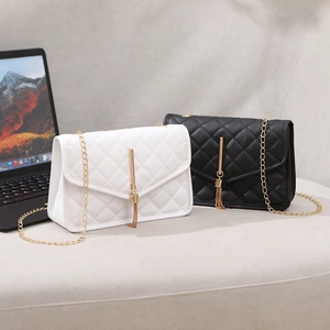 Quilted mini crossbody bags in black and white with gold chain and tassel detail