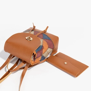 Brown faux leather drawstring bucket backpack with colorful argyle pattern and small purse