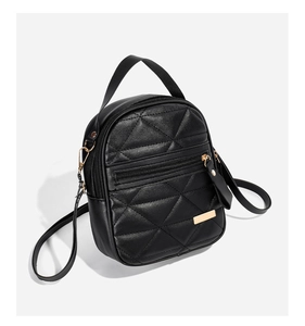 Détail du mini sac à dos noir avec matelassage en losange et fermetures dorées