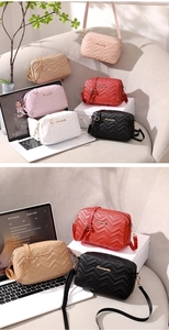 Detailed view of six quilted crossbody bags in varied colors arranged in a home setting