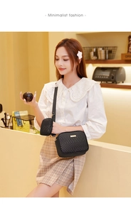 Detail of black crossbody bag set with V-quilted faux leather and gold metal logo plate