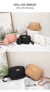 Detailed view of a quilted V-stitch camera bag with small pouch charm and fabric strap