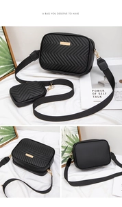 Detail of black chevron quilted crossbody bag with a round mini coin purse attachment