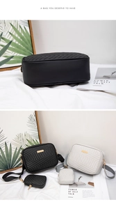 Close-up of quilted crossbody camera bag set with mini pendant and gold hardware