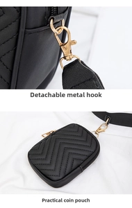 Detail of black V-quilted handbag featuring detachable golden hardware and small coin pouch