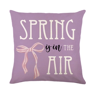 Lavender spring cushion cover with purple bow and 'SPRING is in THE AIR' text print