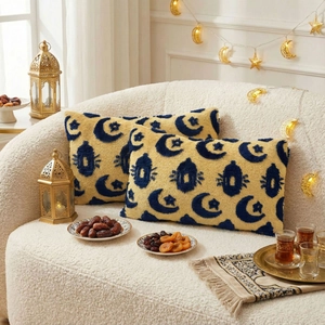 Yellow tufted decorative pillows with moon and lantern patterns on a white sofa