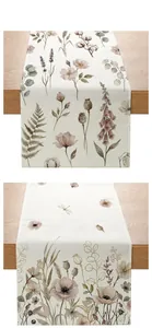Close-up of linen table runner with vintage floral print and woven texture on wood