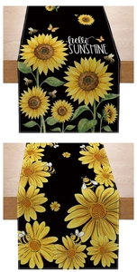 Detailed view of sunflower table runners with bee patterns and rustic linen texture
