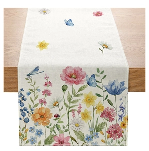 Detail of floral table runner with watercolor flowers and insects on linen fabric