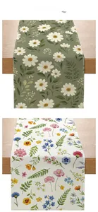 Close-up of pastoral floral table runners showing digital print detail and linen texture