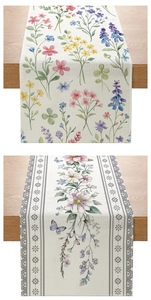 Close-up of floral table runner with colorful wild flowers and linen fabric texture