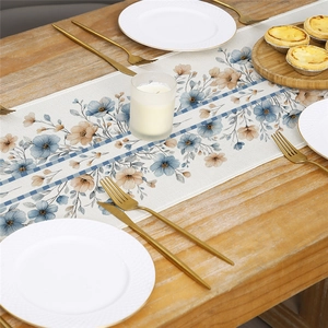 Floral watercolor table runner with blue checkered borders on a rustic wooden dining table
