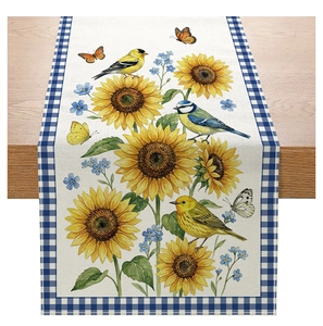 Detailed view of floral table runner with sunflowers, birds and blue checkered borders