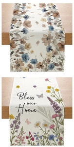 Close-up of linen table runner showing floral patterns and Bless our Home text