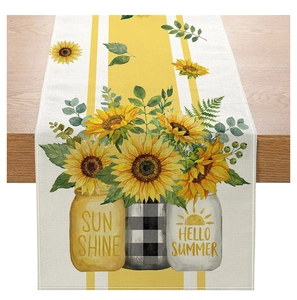 Detail of sunflower table runner with Hello Summer text on rustic wooden table edge