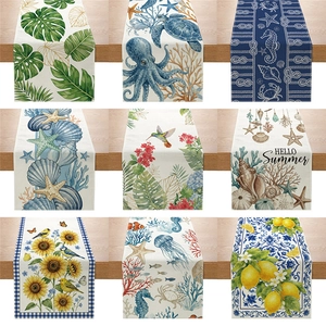 Pastoral table runner set with floral, bird and ocean patterns on light wood background