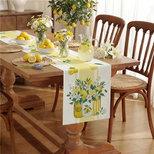 Table runner with lemon and white flower illustrations on a yellow striped background
