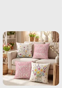 Detail von vier floralen Frühlings-Kissenbezügen mit Blumenschrift auf dem Sofa