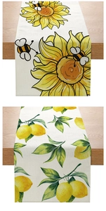 Detail of sunflower and lemon print table runners with rustic linen texture on wood