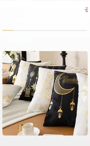 Detail of moon and star gold foil stamping on plush black and white cushion covers
