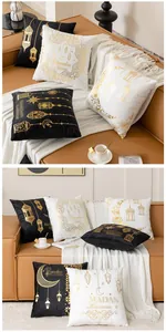 Detail of Ramadan cushion cover showing gold foil crescent moon and star patterns on velvet