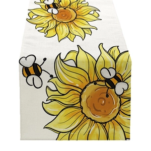 Floral table runner featuring sunflower and bee patterns on textured linen fabric