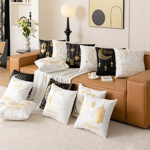 Star and moon gold foil decorative pillow covers on leather sofa in cozy living room
