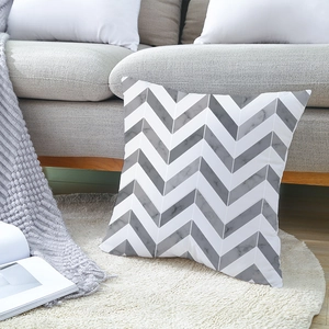 Modern minimalist grey chevron marble pattern pillow cover on a plush carpet