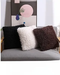 Detail of plush faux fur pillows in black, white, and brown on a modern sofa