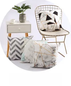 Detail of four geometric marble pattern decorative cushion covers in a modern home setting