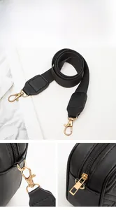 Detail of black crossbody bag with gold hardware, adjustable strap and quilted texture