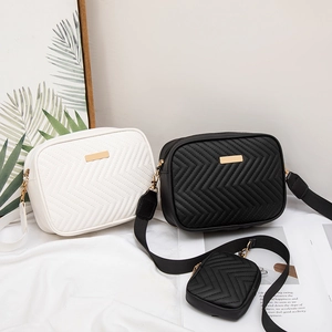Quilted camera bags in black and white with gold hardware and wide straps set