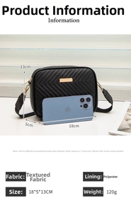 Detail view of black quilted crossbody bag with gold zippers and size comparison to a phone