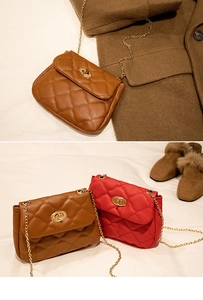 Close-up of quilted pattern faux leather bags with gold twist locks and chain straps