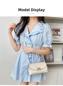 Model wearing a cream lychee pattern leather crossbody bag with golden metal lock