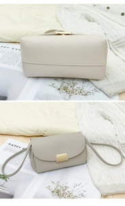 Detail of lychee textured crossbody bags with magnetic gold buckle and sleek shoulder strap