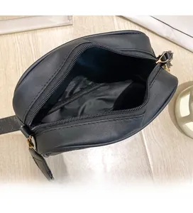 Internal view of black quilted crossbody bag showing spacious main compartment and zipper