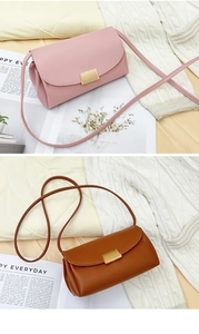 Detail view of pink and brown crossbody bags with litchi texture and gold metal clasp