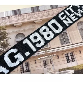 Detail of wide black fabric shoulder strap with G-1980 NEW white letter embroidery