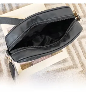 Top view of spacious black quilted camera bag interior with premium metal zipper closure