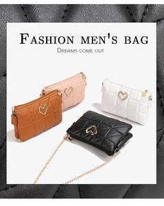 Close-up of quilted crossbody bags with heart-shaped gold buckles and chain straps