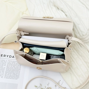 Beige lychee texture flap bag with multi-layer interior and magnetic buckle closure
