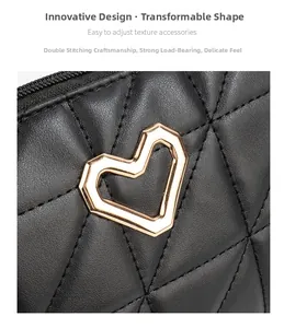Detail of black quilted leather bag with golden heart hardware and reinforced double stitching