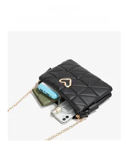 Detail view of black quilted crossbody bag showing large internal capacity for phone and wallet