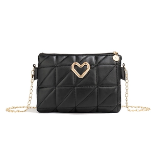 Black quilted crossbody bag with golden heart clasp and chain strap on white background
