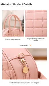 Detail of pink quilted handbag showing smooth top handles and golden zipper pendant