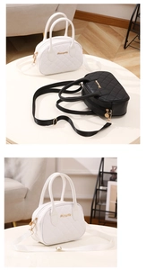 Detailed view of quilted bowling bags in black and white with gold hardware and strap