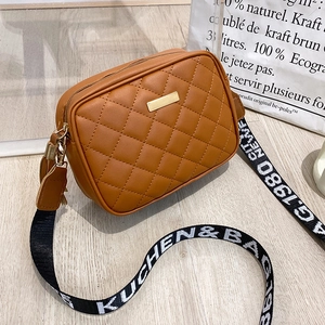 Caramel brown quilted crossbody camera bag with stylish wide fabric strap and gold hardware